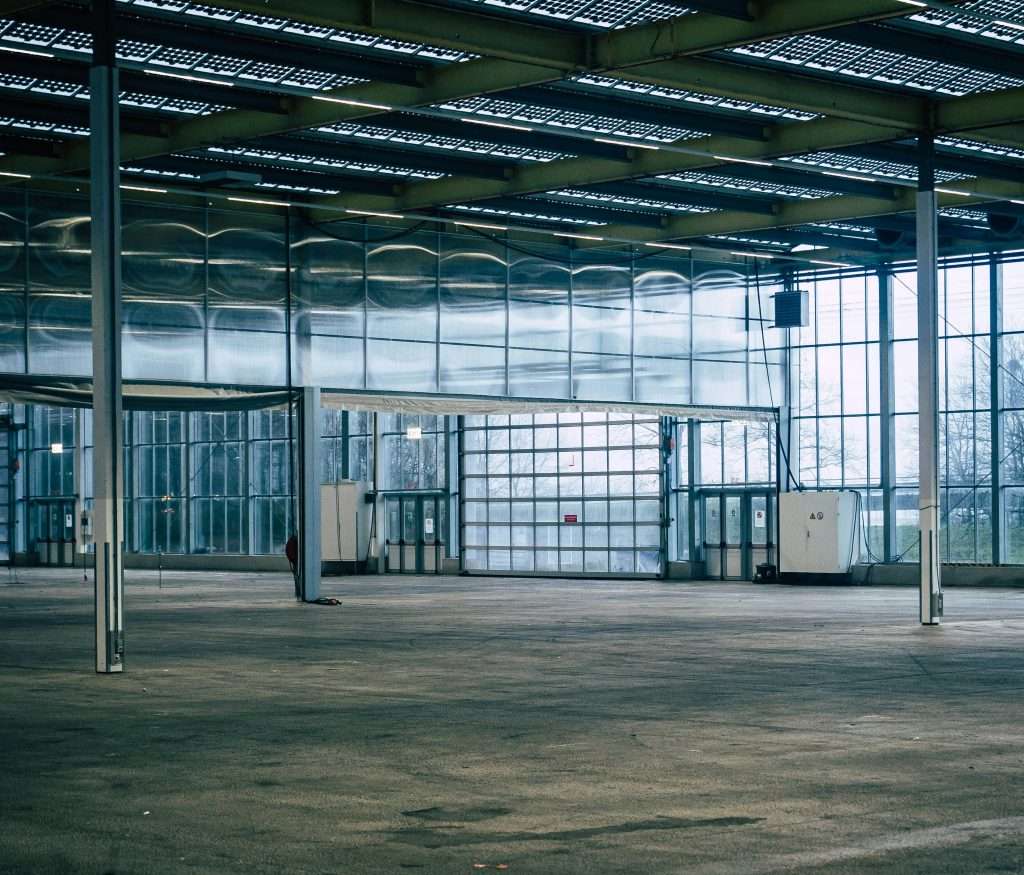 large glass windows in warehouses, arenas, and lobbies create blinding glare that makes customers avoid areas. anti-reflective film solves it.